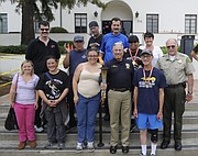 SPBD Chief Cam Sanchez (center) and Lt. Butch Arnoldi with the Sheriff's Department meet with Special Olympics athletes.