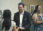 Travis Wilson (center) and Cuca Acosta with the Adsum Education Foundation present scholarships to AB540 students at the Faulkner Gallery (Aug 12, 2015)
