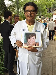 Dr. Robert Olvera holds a photo of his daughter, who died while suffering from leukemia.