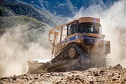 A Santa Barbara County dozer cuts a break down a steep section in San Ysidro Canyon to provide a containment line around the east side of the fire.