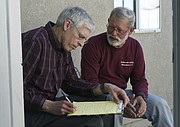 Scott Fina (left) and Dennis Apel take notes during an interview of a farm worker at the Beatitude House in Guadalupe, CA. (May 15, 2015) .