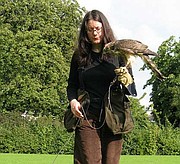 <strong>FEATHERED FRIEND:</strong> Author Helen Macdonald and her goshawk, Mabel, train on a green behind Cambridge University.