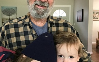 THIS IS WHY: Author Allen DeForrest holds his grandchildren, whom he calls his personal motivators to reduce the severity of the climate change the next generations will face.