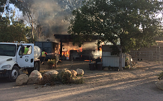County Transfer Station employees Bill Tonoli (in cab) and Chase Deasde (on hose) held the fire down with water from a dust control truck until firefighters could arrive to Hearts Therapeutic Equestrian Center.