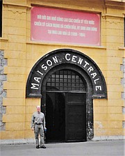 Graham stands before Hoa Lo Prison, better known as the Hanoi Hilton, which housed POW Lt. Commander John McCain for five torturous years.