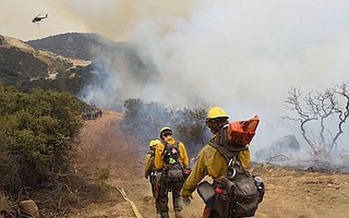 Near Bee Rock off Highway 154, a Forest Service Hot Shot crew gets ready to remove thick brush for a firebreak.