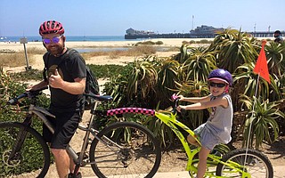 Jim Cadenhead and daughter Esther enjoy a bike ride along the waterfront.