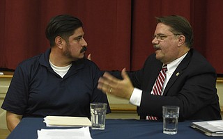 Frank Rodriguez with CAUSE (left) and Sheriff Bill Brown discuss Senate Bill 54 at the Unitarian Society of Santa Barbara town hall meeting.