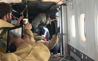 Smokejumpers from the U.S. Forest Service prepare to deploy.