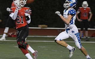 Bishop Diego High’s Isaiah Veal (21) gathered in a long pass during the Cardinals’ 59-21 victory over San Marino in the CIF Division 6 playoffs last week. The Cardinals (11-1) will play in the semifinals for the seventh time in 12 years Friday, when they travel to Saugus.