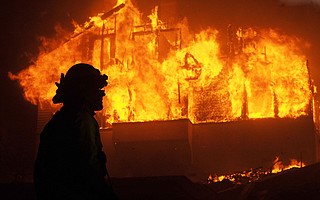 A home is engulfed in Thomas Fire flames at the corner of North Fir and Buena Vista streets.