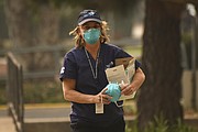 Nurse Practitioner Samvada Hillow with the Santa Barbara County Medical Reserve Corp distributes N95 masks available to the public through a partnership with Direct Relief at the Franklin Community Center. (Dec. 8, 2017)