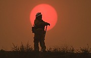 Thornton Fire Chief Everett Watkins, working as an engineer on the Thomas Fire, keeps an eye on flames off of East Mountain Drive on December 16, 2017.