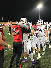 Bishop Diego defender Will Goodwin (80) and Detrius Kelsall, a powerhouse player for Shasta, show mutual respect after their battle for the California crown.