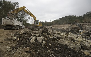 Heavy machinery works to break down and truck out boulders from the Cold Spring Creek debris basin. (Jan. 19, 2018)