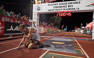 Kris Brown dropped to the track at Placer High after becoming the 10th runner to finish the 100-mile Western States race on June 23.