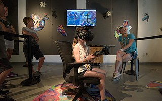 Branna Burke, visiting from Ventura, experiences Blortasia, a virtual-reality exhibit at the Wolf Museum of Exploration + Innovation (MOXI)