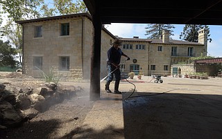 Mounting cleanup and rebuilding costs have prompted retreat leaders to lay off employees and temporarily close La Casa de Maria’s doors.