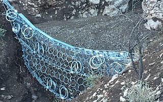 A ring net holds back mud and debris in Camarillo Springs.