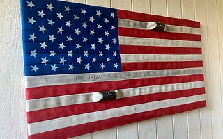 Retired firefighter John Carrillo created flag from old hose material.