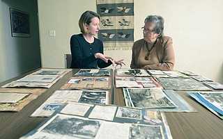 Conservator Christina Bean (left) and Stephanie Glatt, director emerita at La Casa de Maria, go over some of the photos salvaged following the 1/9 Debris Flow.
