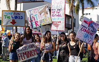 Young women represent at Women's March 2019.