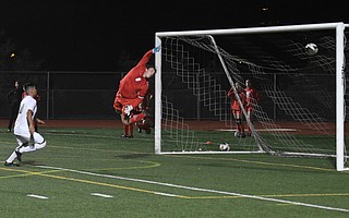San Marcos goalkeeper Bryce Tomlinson can only leap and wave as a 19-yard free kick by Santa Barbara High’s Juan Carlos Torres swerves into the net.