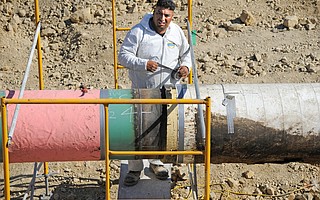 A crew member repairs the Plains pipeline section that leaked crude on Refugio Beach in 2015.