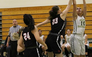Payton Johnson goes up for a shot over the oustretched arm of Amelia Schariff.