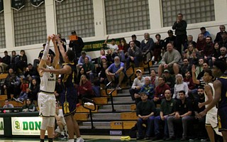 Bryce Warrecker drains a fourth quarter three pointer over a leaping Joseph Octave.
