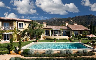 Covering 5,500 square feet with four bedrooms and four baths, this French-Italian farmhouse features imported limestone fireplace surrounds, hand-hewn oak beams from the 19th century, and — to meet strict wildfire building codes — sprinklers and tempered glass.
