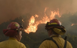 Cal Fire firefighters from Norco, California work to defend homes near Casitas Pass on the morning of Monday, December 11.